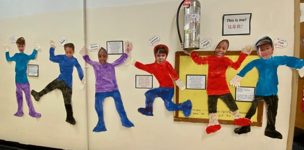 Student self-portraits are displayed on the wall.  